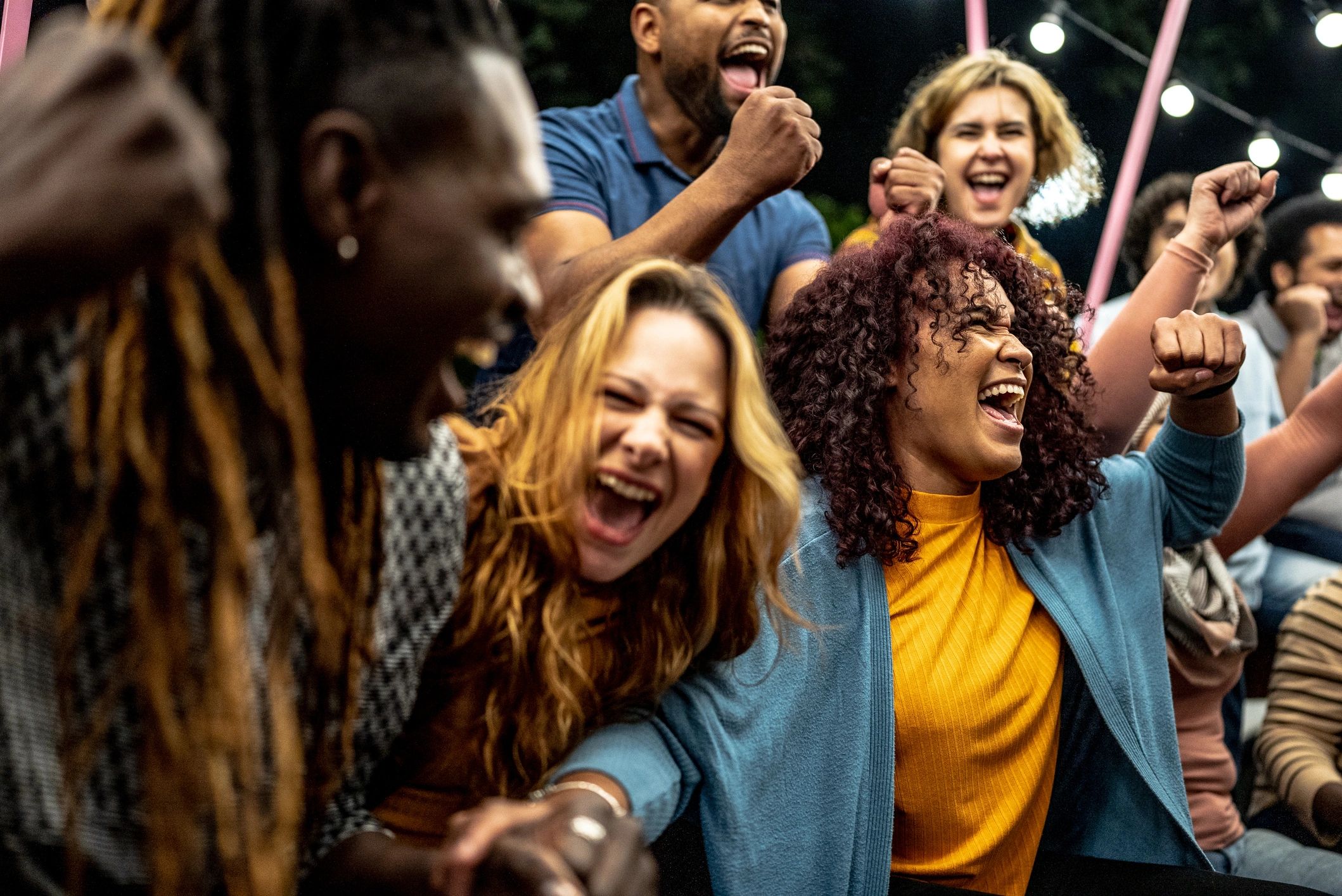 Friends celebrating together while watching a sporting event