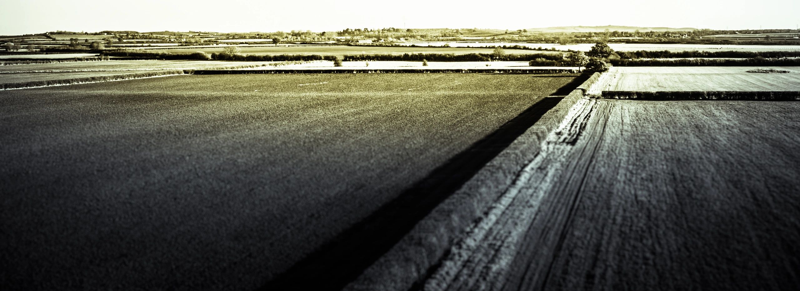 Aerial view of a sweeping landscape evoking the speed and scale of motorsport